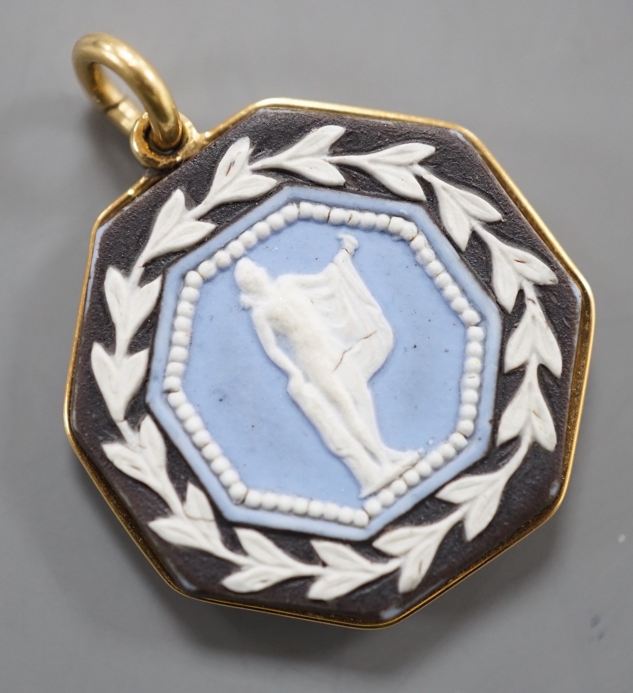 A late 19th/early 20th century yellow metal and two colour Wedgwood double sided octagonal pendant, 21mm.
